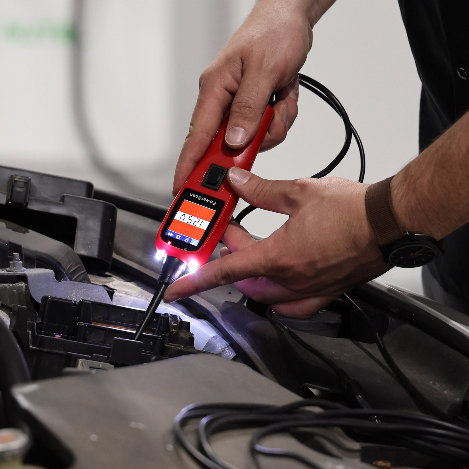 Technician testing fuse using PS100.